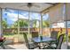 Relax on the screened porch with a table and chairs, and enjoy views of the backyard at 411 Freeland Way, Moncks Corner, SC 29461