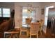 A cozy dining area with a glass-top table and upholstered chairs, illuminated by a chandelier at 4210 Scharite St, Charleston, SC 29414