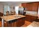 A stylish kitchen featuring granite countertops, stainless steel appliances and light wood flooring at 4210 Scharite St, Charleston, SC 29414