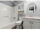 Modern bathroom featuring a shower-tub combo, white cabinets, a round mirror and updated fixtures at 422 Temple Rd, Ladson, SC 29456