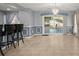 Dining area with tile floor, modern chandelier, sliding glass doors to the patio, and stylish wainscoting at 422 Temple Rd, Ladson, SC 29456