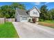 Inviting exterior with grey siding, neat landscaping, and a concrete driveway leading to the charming two-story home at 422 Temple Rd, Ladson, SC 29456