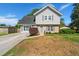 Charming two-story home featuring a well-maintained front yard, blue door, and brick and siding accents at 422 Temple Rd, Ladson, SC 29456