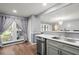 Modern kitchen with stainless steel dishwasher, gray cabinets, and hardwood flooring at 422 Temple Rd, Ladson, SC 29456
