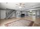 Open-concept living room featuring a staircase, tile flooring, wainscoting and bar seating area at 422 Temple Rd, Ladson, SC 29456