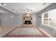 Bright living room featuring a brick fireplace, ceiling fan, a large window, and neutral color palette at 422 Temple Rd, Ladson, SC 29456