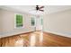 Bedroom with hardwood floors, two windows, a ceiling fan, and a view into the hallway at 43 Montrose Rd, Mount Pleasant, SC 29464
