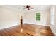 Bedroom featuring hardwood floors, a ceiling fan, and a view into the bathroom at 43 Montrose Rd, Mount Pleasant, SC 29464