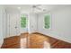 Bright bedroom featuring hardwood floors, white trim, and natural light from the windows at 43 Montrose Rd, Mount Pleasant, SC 29464