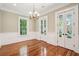 Bright dining room with hardwood floors, elegant chandelier, and view to outside at 43 Montrose Rd, Mount Pleasant, SC 29464