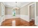 Elegant dining room with hardwood floors, wainscoting, and a classic chandelier at 43 Montrose Rd, Mount Pleasant, SC 29464