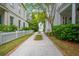 Long driveway leading to a house with lush greenery, trees, and shrubbery alongside it at 43 Montrose Rd, Mount Pleasant, SC 29464