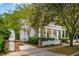 Charming exterior showcasing a white home with a welcoming front porch and picket fence at 43 Montrose Rd, Mount Pleasant, SC 29464