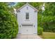 Charming white detached garage with red metal roof and well manicured landscaping at 43 Montrose Rd, Mount Pleasant, SC 29464