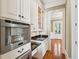 Gourmet kitchen featuring sleek countertops, custom cabinets, and stainless steel coffee system at 43 Montrose Rd, Mount Pleasant, SC 29464
