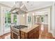 Kitchen with gas range, stainless vent hood, wooden island, and doors opening onto a porch at 43 Montrose Rd, Mount Pleasant, SC 29464