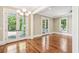 Living room featuring hardwood floors, a chandelier, and doors leading to the outside porch at 43 Montrose Rd, Mount Pleasant, SC 29464