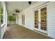 Inviting covered porch featuring ceiling fans and multiple glass doors leading inside at 43 Montrose Rd, Mount Pleasant, SC 29464
