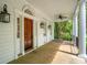 Spacious porch features wooden flooring, lantern fixtures, and views of the outdoor scenery at 43 Montrose Rd, Mount Pleasant, SC 29464
