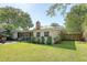A beautiful backyard features a screened porch, lush lawn, and mature trees at 45 Lyttleton Ave, Charleston, SC 29407