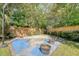 A fenced backyard with basketball court, mature trees, and some flowerpots at 45 Lyttleton Ave, Charleston, SC 29407