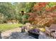 Backyard patio features a cozy seating area with a fire pit and a lush lawn at 45 Lyttleton Ave, Charleston, SC 29407