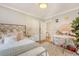 Cozy bedroom featuring a patterned rug, white bedding, and a view into an adjacent room at 45 Lyttleton Ave, Charleston, SC 29407