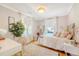 Bright bedroom with hardwood floors, white walls, and plenty of natural light from two large windows at 45 Lyttleton Ave, Charleston, SC 29407