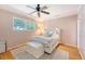 Cozy bedroom with soft lighting, neutral decor, a ceiling fan and a view of backyard trees at 45 Lyttleton Ave, Charleston, SC 29407