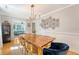 Dining room with rustic wood table, unique chandelier, and gallery wall at 45 Lyttleton Ave, Charleston, SC 29407