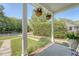 View from the front porch showing hanging flower baskets and manicured lawn at 45 Lyttleton Ave, Charleston, SC 29407