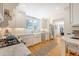 Bright kitchen features white cabinets, countertops, stainless appliances, and a window over the farmhouse sink at 45 Lyttleton Ave, Charleston, SC 29407