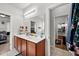 Bright bathroom with double sink vanity and views to the kitchen and main bedroom at 514 Morelets Dr, Moncks Corner, SC 29461