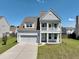 Charming two-story home with a double front porch, well-maintained lawn and a two car garage at 514 Morelets Dr, Moncks Corner, SC 29461