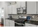 Updated kitchen featuring stainless steel appliances, granite countertops, and stylish backsplash at 514 Morelets Dr, Moncks Corner, SC 29461
