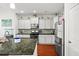 Modern kitchen with stainless steel appliances, granite counters, and white cabinetry at 514 Morelets Dr, Moncks Corner, SC 29461