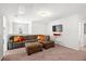 Living room with a large sectional sofa, ottoman, TV, and cozy carpet at 514 Morelets Dr, Moncks Corner, SC 29461