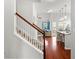 Open concept, showing staircase, wood floors and ample natural light enhance this inviting living space at 514 Morelets Dr, Moncks Corner, SC 29461