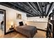 Stylish bedroom with exposed ceiling pipes, modern lighting, and comfortable furnishings at 517 King St # 1, Charleston, SC 29403