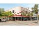 Beautiful Art Deco building in downtown Charleston boasting a rounded corner, tropical trees, and inviting storefronts at 517 King St # 1, Charleston, SC 29403