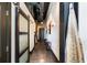 Hallway featuring a sliding wood-paneled door, polished concrete floors and exposed ductwork at 517 King St # 1, Charleston, SC 29403