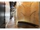 Modern hallway featuring a decorative brick wall and industrial design elements, leading to a spiral staircase at 517 King St # 1, Charleston, SC 29403