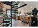 A luxurious open-concept kitchen showcasing a spiral staircase, stainless steel appliances and bar seating at 517 King St # 1, Charleston, SC 29403