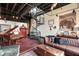 Open-concept living room featuring a spiral staircase, piano, hardwood floors, and stylish decor at 517 King St # 1, Charleston, SC 29403