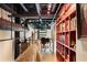 Hallway featuring a spiral staircase, a saddle on the railing and an exposed black ceiling with pipe at 517 King St # 1, Charleston, SC 29403