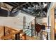 Hallway featuring a spiral staircase, a saddle on the railing and an exposed black ceiling with pipe at 517 King St # 1, Charleston, SC 29403