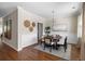 Inviting dining room with hardwood floors, decorative wall art, and a stylish round table at 547 Nelliefield Trl, Wando, SC 29492