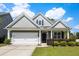 Charming single-Gathering home featuring a well-manicured lawn and an attached two-car garage at 547 Nelliefield Trl, Wando, SC 29492