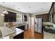 Modern kitchen featuring dark cabinets, granite countertops, and stainless steel appliances at 547 Nelliefield Trl, Wando, SC 29492