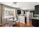 Eat-in kitchen area with stainless steel appliances, dark cabinetry, and hardwood floors at 547 Nelliefield Trl, Wando, SC 29492